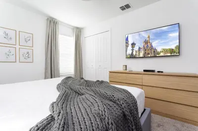 a bedroom with a bed and a tv on the wall at Last Minute Disney Getaway Private Pool Themed Bedrooms. Book Now 99589 in Kissimmee