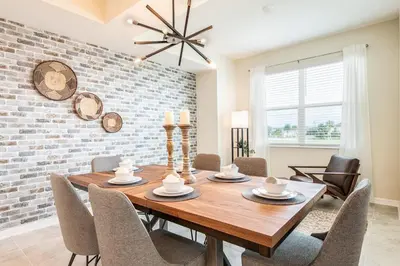 a dining room with a wooden table and chairs at Storey Lake Resort 1053 - Hosted by Top Villas in Kissimmee