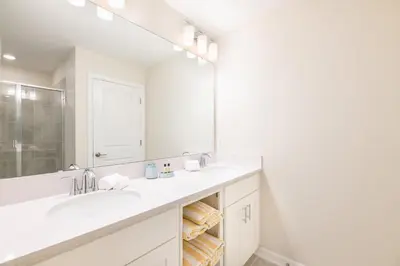 a white bathroom with a sink and a mirror at Storey Lake Resort 1053 - Hosted by Top Villas in Kissimmee