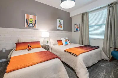 a bedroom with two beds and a window at Storey Lake Resort 1053 - Hosted by Top Villas in Kissimmee