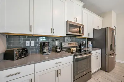 a kitchen with white cabinets and stainless steel appliances at Storey Lake Resort 1071 - Hosted by Top Villas in Kissimmee