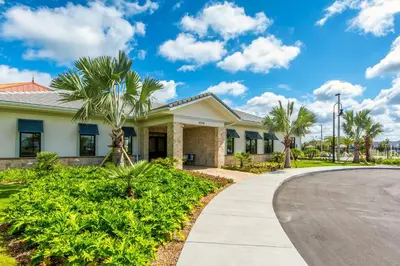 a house with palm trees and a driveway at Storey Lake Resort 1071 - Hosted by Top Villas in Kissimmee