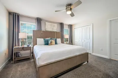 a bedroom with a large bed and a ceiling fan at Storey Lake Resort 1071 - Hosted by Top Villas in Kissimmee