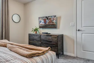 a bedroom with a dresser and a picture on the wall at Storey Lake Resort 1081 - Hosted by Top Villas in Kissimmee