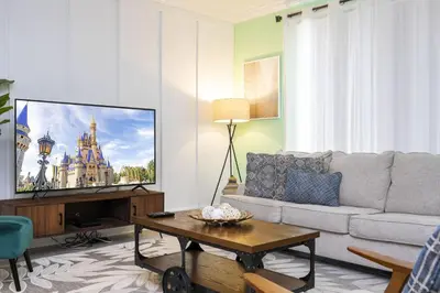 a living room with a couch and a flat screen tv at Storey Lake Resort 1082 - Hosted by Top Villas in Kissimmee