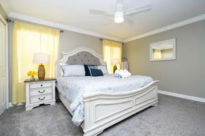 a bedroom with a white bed and a ceiling fan at Storey Lake Resort 1082 - Hosted by Top Villas in Kissimmee