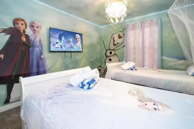 a bedroom with two beds and a painting on the wall at Storey Lake Resort 1082 - Hosted by Top Villas in Kissimmee
