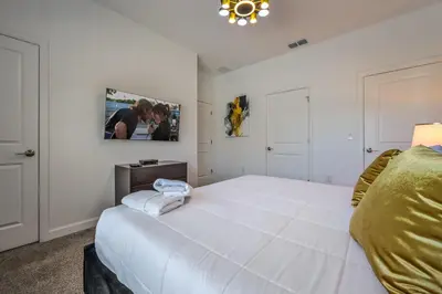 a bedroom with a large white bed in a room at Storey Lake Resort 1085 - Hosted by Top Villas in Kissimmee