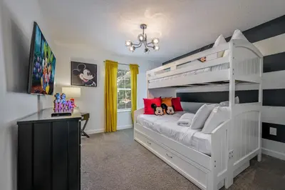 a bedroom with a white bunk bed and a desk at Storey Lake Resort 1085 - Hosted by Top Villas in Kissimmee