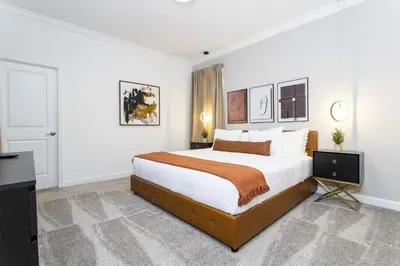 a bedroom with a large bed with white walls at Storey Lake Resort 1086 - Hosted by Top Villas in Kissimmee