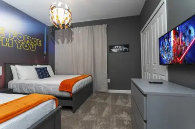 a hotel room with two beds and a flat screen tv at Storey Lake Resort 1086 - Hosted by Top Villas in Kissimmee