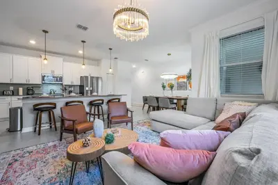 a living room with a couch and a kitchen at Storey Lake Resort 1088 - Hosted by Top Villas in Kissimmee