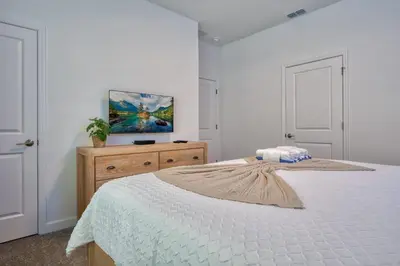 a bedroom with a bed and a painting on the wall at Storey Lake Resort 1088 - Hosted by Top Villas in Kissimmee