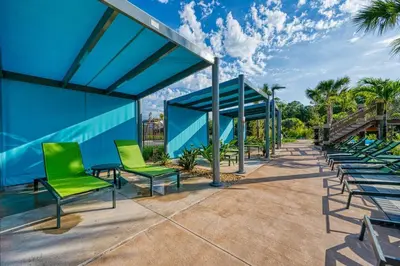 a group of green chairs and a blue building at Storey Lake Resort 1092 - Hosted by Top Villas in Kissimmee