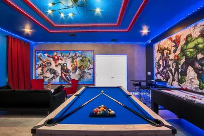 a room with a pool table and a marvel mural at Storey Lake Resort 1095 - Hosted by Top Villas in Kissimmee