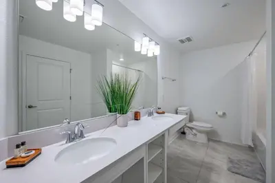 a white bathroom with a sink and a mirror at Storey Lake Resort 1099 - Hosted by Top Villas in Kissimmee