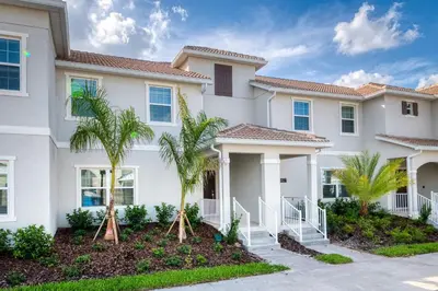 a house with palm trees in front of it at Storey Lake Resort 1107 - Hosted by Top Villas in Kissimmee