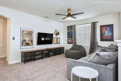 a living room with a couch and a flat screen tv at Storey Lake Resort 1110 - Hosted by Top Villas in Kissimmee