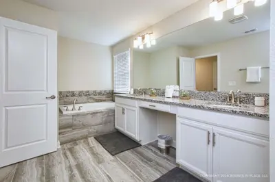 a bathroom with a tub and a sink and a bath tub at Storey Lake Resort 1110 - Hosted by Top Villas in Kissimmee