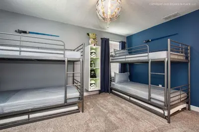 two bunk beds in a room with blue walls at Storey Lake Resort 1110 - Hosted by Top Villas in Kissimmee