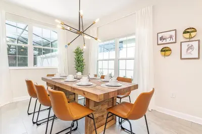 a dining room with a wooden table and chairs at Storey Lake Resort 1113 - Hosted by Top Villas in Kissimmee
