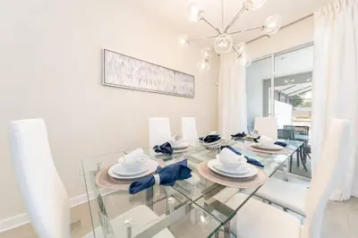 a dining room with a glass table and chairs at Last Minute Disney Getaway Townhouse with Private Pool. Book Now 27412 in Kissimmee