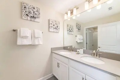 a bathroom with two sinks and a mirror at Last Minute Disney Getaway Townhouse with Private Pool. Book Now 27412 in Kissimmee
