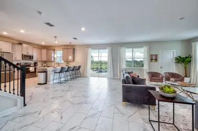 a kitchen and living room with a couch and a table at Last Minute Disney Private Pool Hot Tub Game Room Themed Bedrooms. Book Now 32850 in Kissimmee