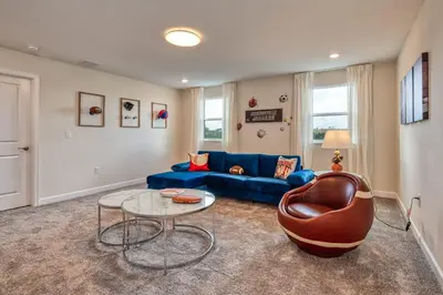 a living room with a blue couch and a glass table at Last Minute Disney Private Pool Hot Tub Game Room Themed Bedrooms. Book Now 32850 in Kissimmee