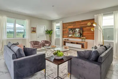 a living room with two couches and a table at Last Minute Disney Private Pool Hot Tub Game Room Themed Bedrooms. Book Now 32850 in Kissimmee