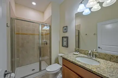 a bathroom with a shower and a sink and a toilet at Last Minute Disney Getaway Townhouse with Private Pool. Book Now 17222 in Kissimmee