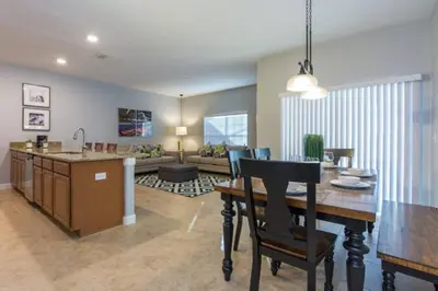 a kitchen and living room with a table and a couch at Last Minute Disney Getaway Townhouse with Private Pool. Book Now 17222 in Kissimmee