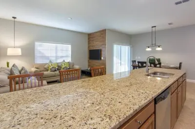 a kitchen with a counter top and a living room at Last Minute Disney Getaway Townhouse with Private Pool. Book Now 17222 in Kissimmee