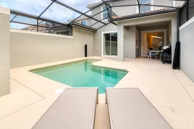 a swimming pool in the backyard of a house at Last Minute Disney Getaway Private Pool Themed Bedrooms. Book Now 98613 in Kissimmee
