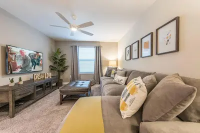 a living room with a couch and a ceiling fan at Storey Lake Resort 61 - Hosted by Top Villas in Kissimmee