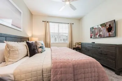 a bedroom with a bed and a ceiling fan at Storey Lake Resort 61 - Hosted by Top Villas in Kissimmee