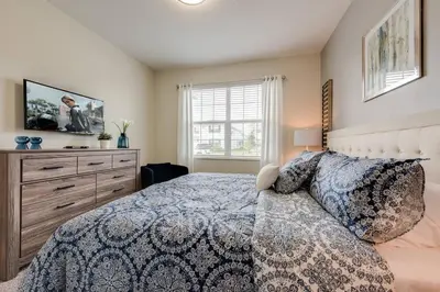 a bedroom with a bed with a tv and a dresser at Last Minute Disney Private Pool Hot Tub Themed Bedrooms. Book Now 17198 in Kissimmee