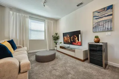 a living room with a couch and a flat screen tv at Last Minute Disney Private Pool Hot Tub Themed Bedrooms. Book Now 54267 in Kissimmee