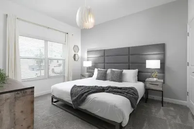 a white bedroom with a large bed and a window at Last Minute Disney Getaway Private Pool Themed Bedrooms. Book Now 58079 in Kissimmee