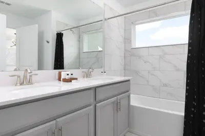 a white bathroom with two sinks and a tub and a window at Last Minute Disney Getaway Private Pool Themed Bedrooms. Book Now 58079 in Kissimmee
