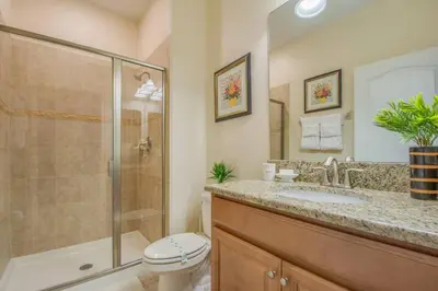 a bathroom with a shower and a toilet and a sink at Last Minute Disney Getaway Townhouse with Private Pool. Book Now 17402 in Kissimmee
