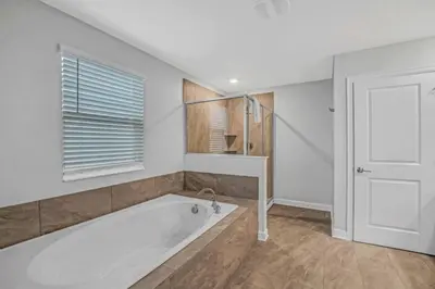 a white bath tub in a room with a window at Storey Lake Resort 972 - Hosted by Top Villas in Kissimmee