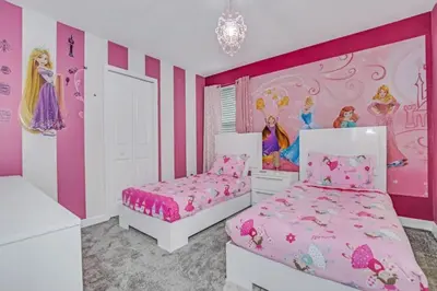 a bedroom with two beds and a princess mural at Storey Lake Resort 972 - Hosted by Top Villas in Kissimmee