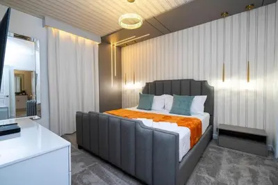 a bedroom with a large bed with an orange blanket at Last Minute Disney Private Pool Hot Tub Game Room Themed Bedrooms. Book Now 90505 in Kissimmee