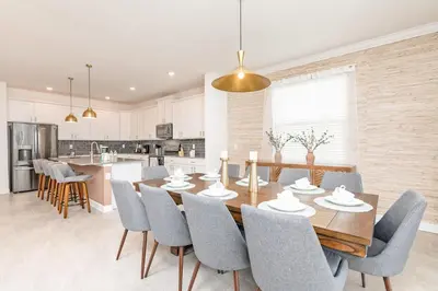 a kitchen and dining room with a wooden table and chairs at Last Minute Disney Getaway Villa with Private Pool Hot Tub. Book Now 81933 in Kissimmee