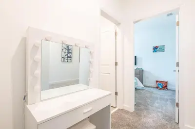a white bathroom with a mirror on a white dresser at Last Minute Disney Getaway Villa with Private Pool Hot Tub. Book Now 81933 in Kissimmee