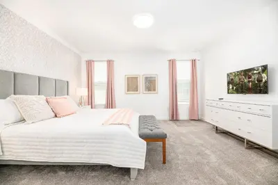 a white bedroom with a large bed and a dresser at Last Minute Disney Getaway Villa with Private Pool Hot Tub. Book Now 81933 in Kissimmee