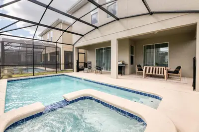 a swimming pool in front of a house at Last Minute Disney Getaway Villa with Private Pool Hot Tub. Book Now 81933 in Kissimmee