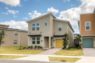 a large house with a yellow garage at Last Minute Disney Getaway Villa with Private Pool Hot Tub. Book Now 81933 in Kissimmee