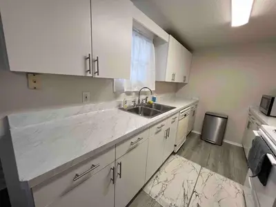 a kitchen with white cabinets and a sink at Home in Kissimmee with Huge Backyard in Kissimmee